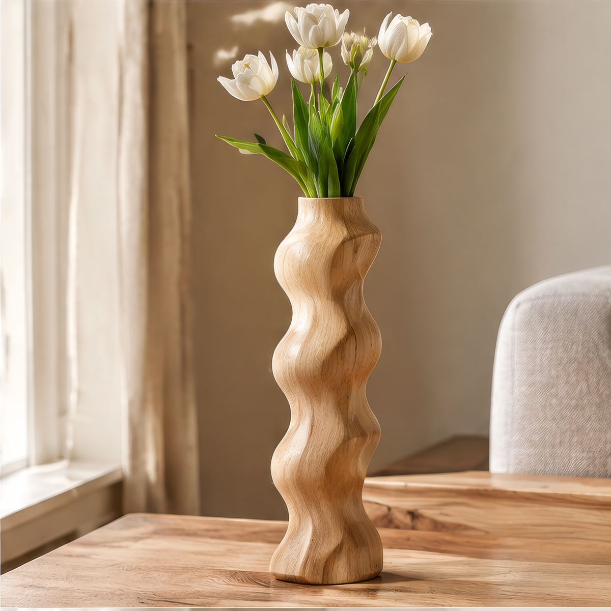 Light wood vase with a tall wavy silhouette and white tulips beside a sunlit window