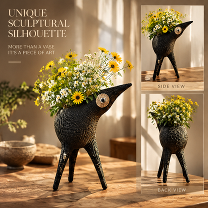 Front, side and back views of the black sculptural bird vase with flowers